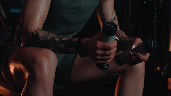 Athlete using KYLA palm cooling devices during rest between sets to support recovery and maintain performance during training