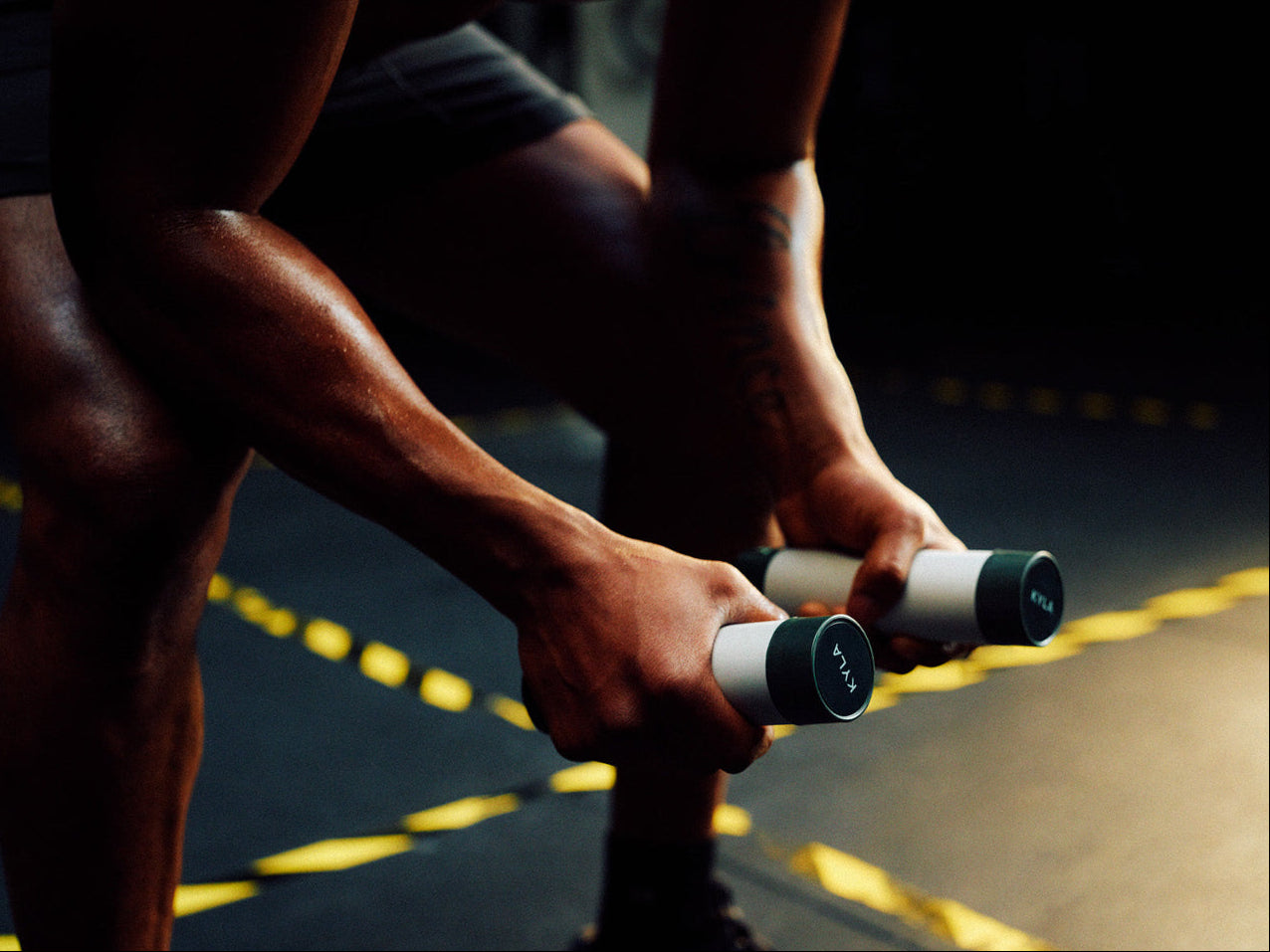 Athlete using KYLA palm cooling device between training efforts to regulate temperature and maintain output